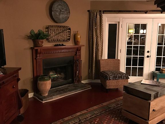 Den with wood burning fireplace