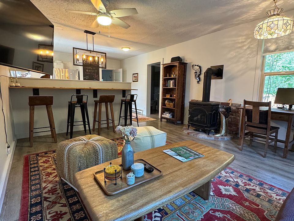Living room with gas fireplace and stool top bench table