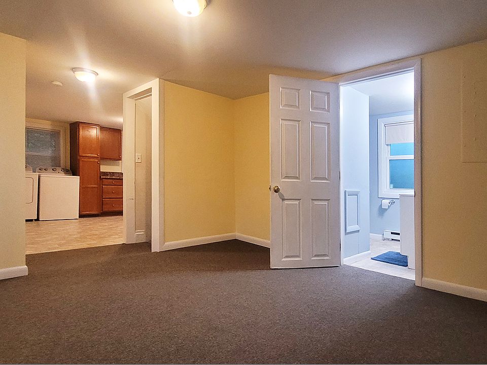 Living room with view into bathroom & kitchen