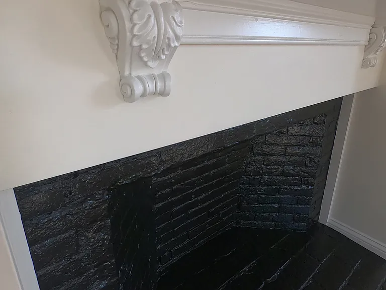 Decorative fireplace in bedroom.