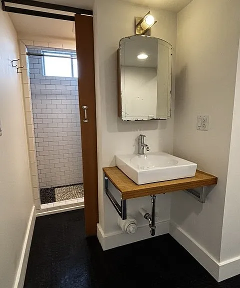 Floating sink, vintage medicine cabinet. Behind this wall is the toilet and shower.