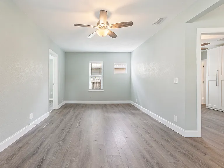 Fresh paint, luxury vinyl plank flooring, and a spacious layout create a warm, welcoming atmosphere in this fully renovated living area.