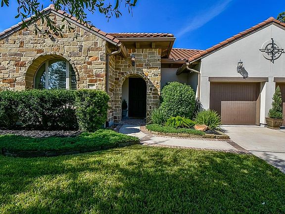 Beautiful stone and stucco 1 story home in The Woodlands Creekside ready to be called home!