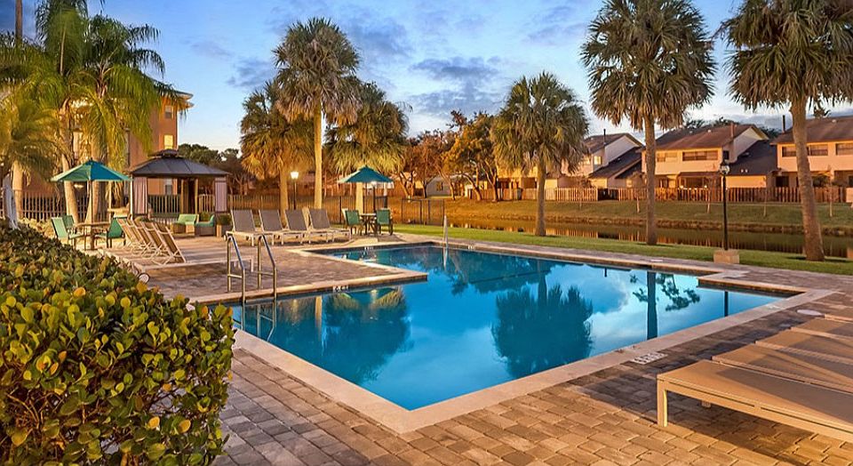 Relax poolside at Midora at Woodmont in Tamarac, FL