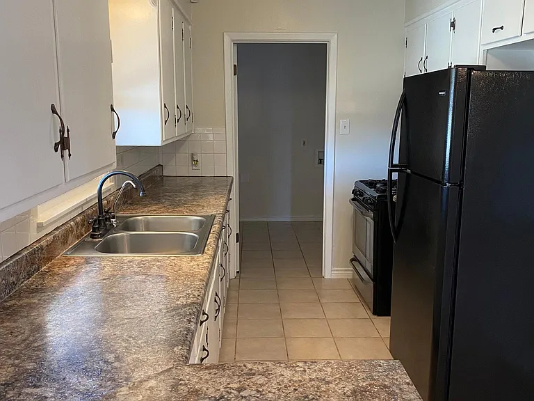Another view of the galley kitchen. You can peep the laundry room area.