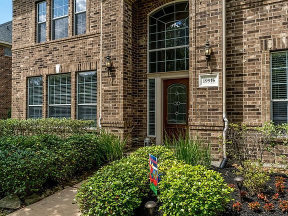 Front landscape has just been refreshed and there's a charming covered porch to greet guests.