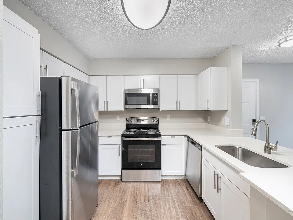 Cook and entertain with ease in a stylish kitchen featuring sleek appliances, granite-inspired countertops, and contemporary details throughout