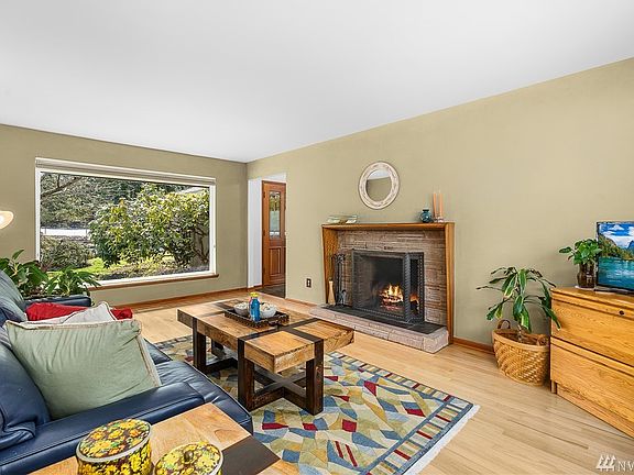 Family room features a wood-burning fireplace.