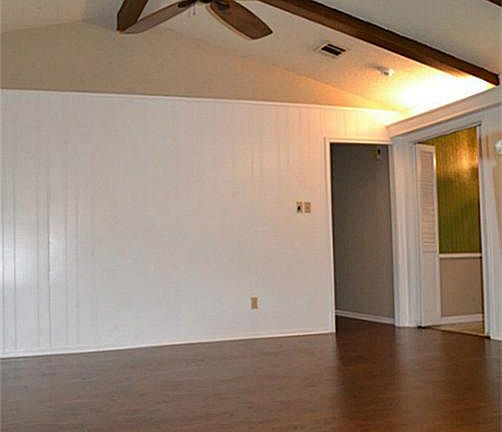 Brand new flooring in the family room and hallway. Lovely wood beams accentuate the high ceilings.