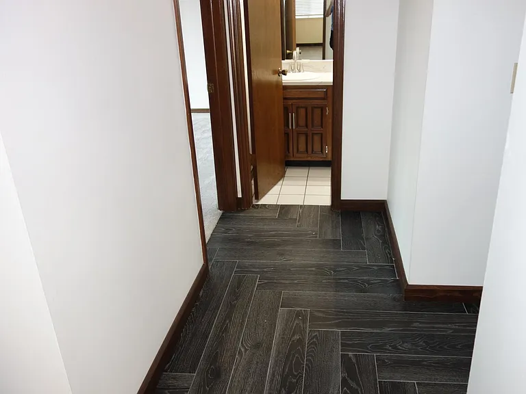 Just off the entry heading to bedroom hallway. Wood look tile floor in herringbone pattern! 1st bedroom on left and Jack and Jill bath straight ahead!