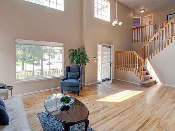 Light streams in through huge clerestory windows, illuminating the living room,