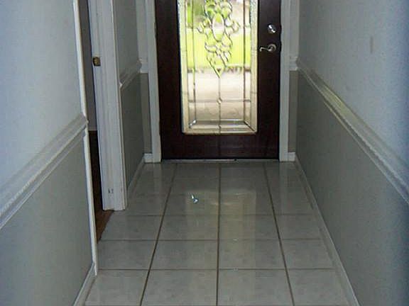 Tile in entry as well as office, living room, dining, kitchen & secondary bedrooms