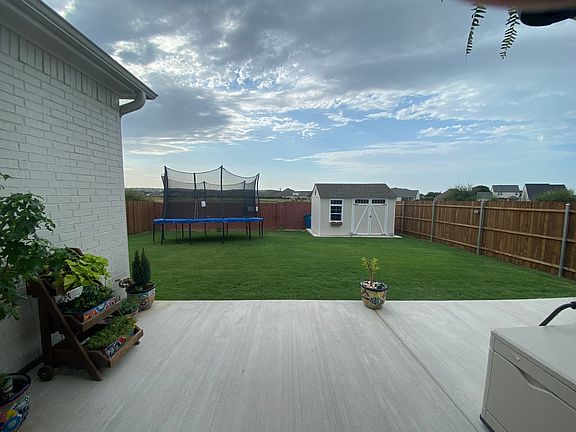 Backyard. Extended Patio and custom shed for extra storage.