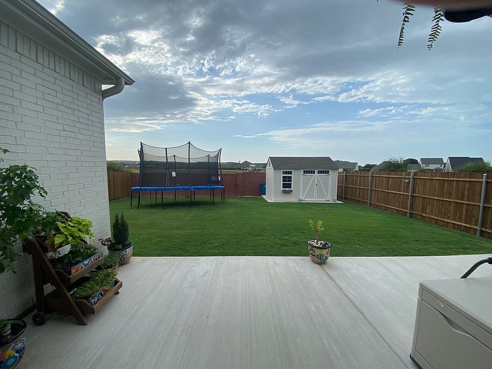 Backyard. Extended Patio and custom shed for extra storage.