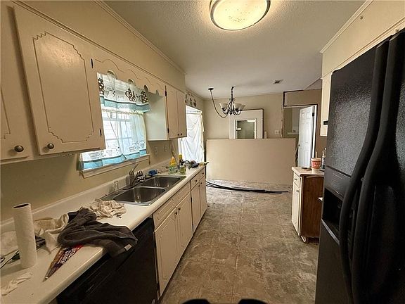 Miscellaneous room featuring vaulted ceiling, a notable chandelier, and visible vents