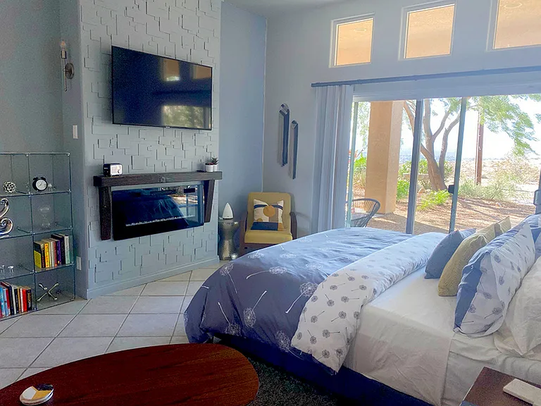Yellow Bedroom: California King size bed, tall ceiling, walk-in closet, electric fireplace, back yard access, expansive desert and mountain views