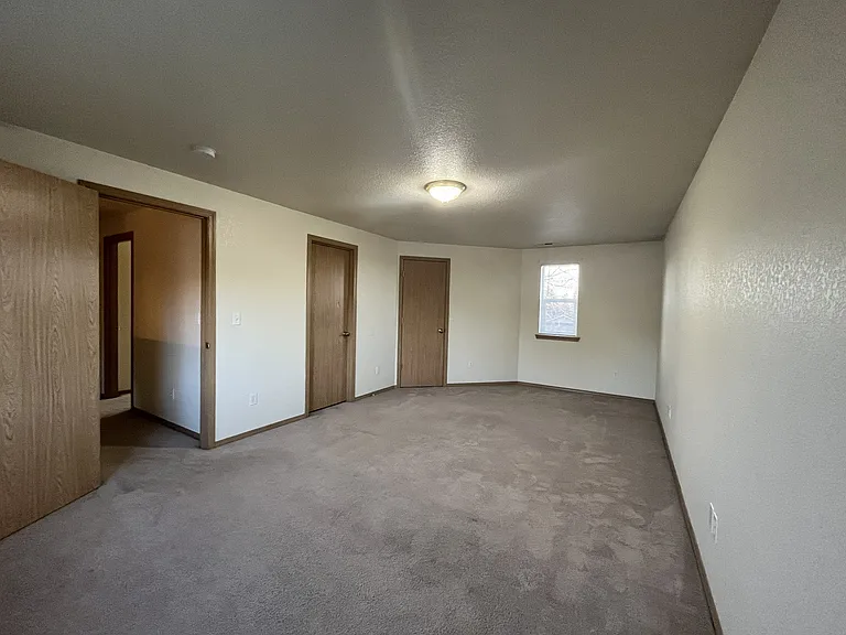 Owner suite bedroom with bathroom and closet doors