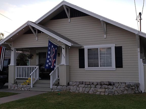 Front of house showing side entry gate. (Planters were being repaired here. They have since been re-planted with flowers and plants.)