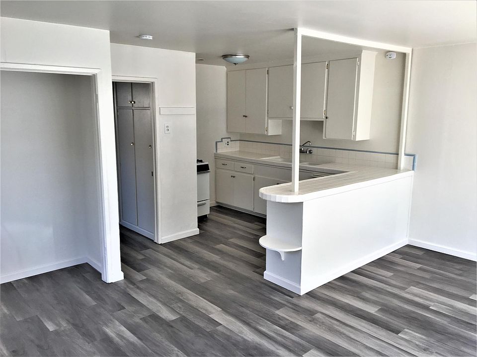 Looking from front door through living room into kitchen