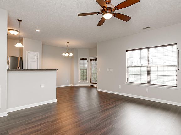 Great Room with Hard Floors, Natural Light, and Ceiling Fan