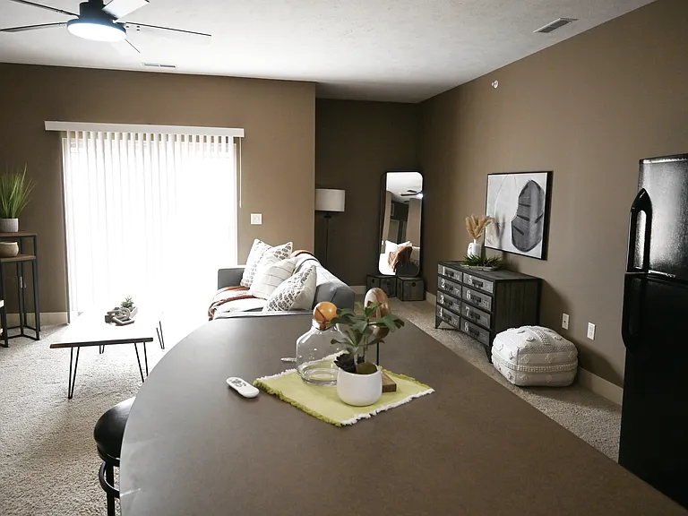 Kitchen island with a view of the living room iin a unit at The Sterling.