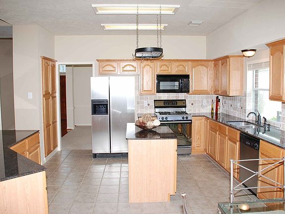 Large island kitchen with granite countertops and stainless steel appliances