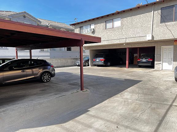 back of the apartment view plus carports and white door is locked laundry room
