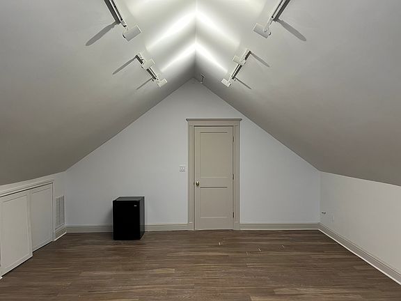 Room looking towards the entry door. Small fridge shows comes with the room.