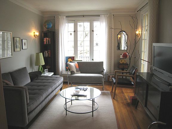 Sunny, floor to ceiling French windows, hardwood floors, illuminated wall sconces - enhanced by contemporary furnishings . . .