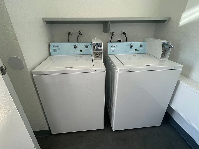 Washing machines in laundry room at Eucalyptus Apartments in Moreno Valley, California.
