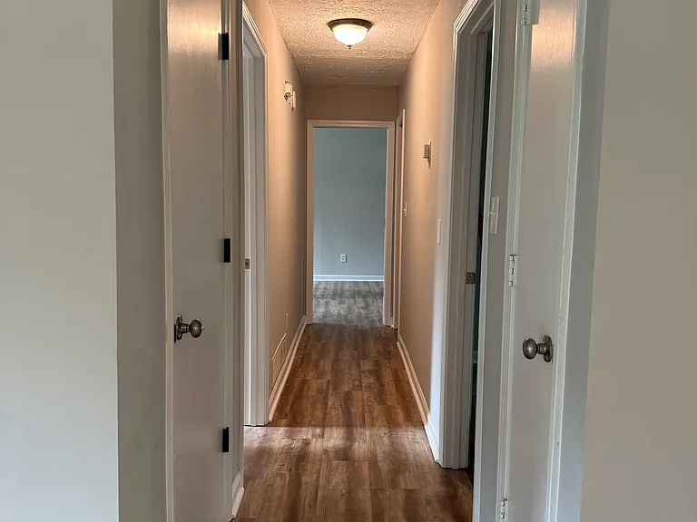 Hallway to 3 bedrooms and 2 bathrooms