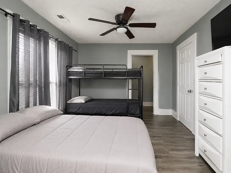 2nd bedroom is pretty large and fits multiple beds. Furniture not included.
