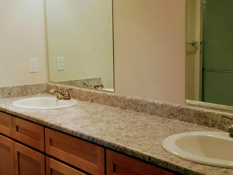 Dual vanities in primary suite bathroom.