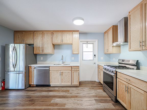 Gourmet kitchen with gas stove and refrigerator plus new oak cabinets and countertops.