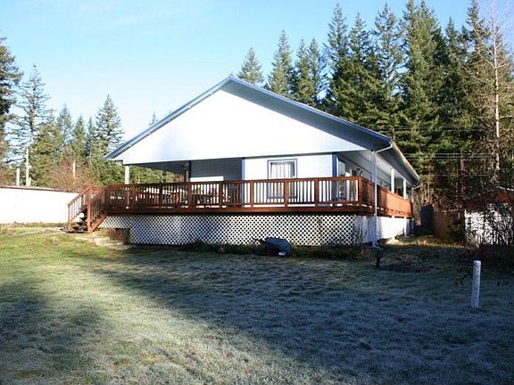Back of house with huge yard and wrap around deck