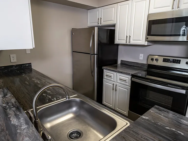 Discover your culinary oasis in our fully-equipped kitchens, boasting stylish cabinetry and stunning granite-style countertops that elevate your cooking haven to new heights.