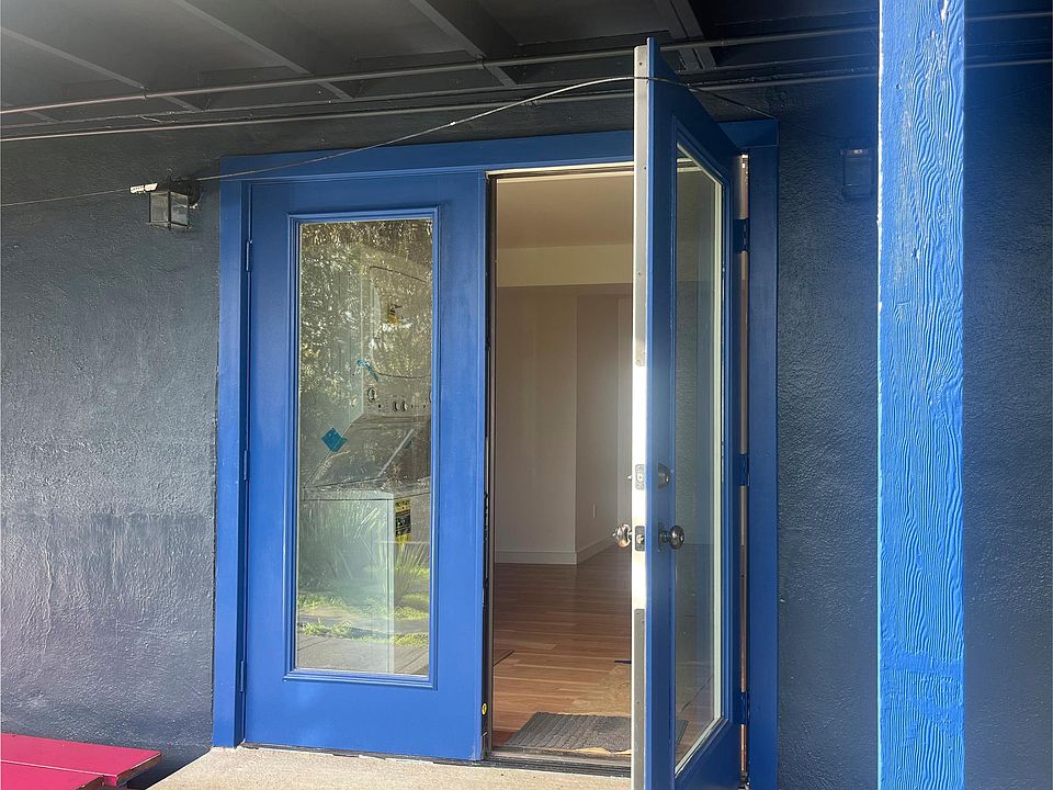 Double French door entrance to rental unit. Facing Garden with morning light.