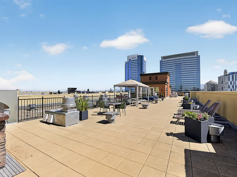Rooftop BBQ and outdoor seating area with views of downtown Oakland.