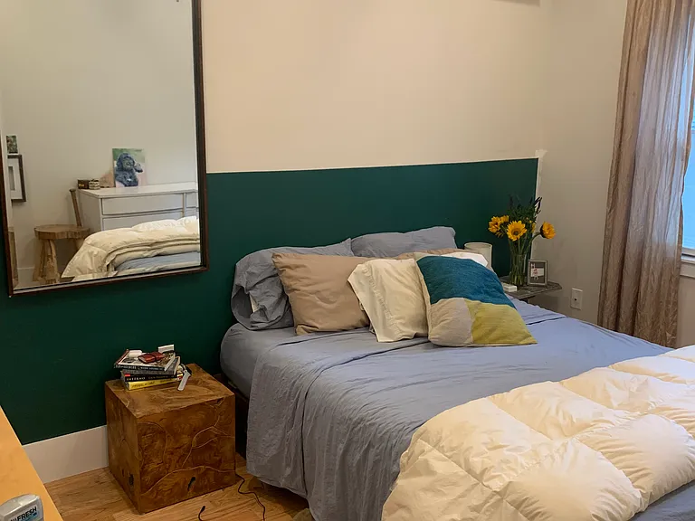 large rear bedroom away from road overlooking mature back patio and garden. Generous double door closet