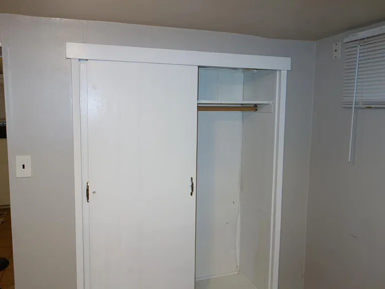 Livingroom closet with bonus shelves on left.