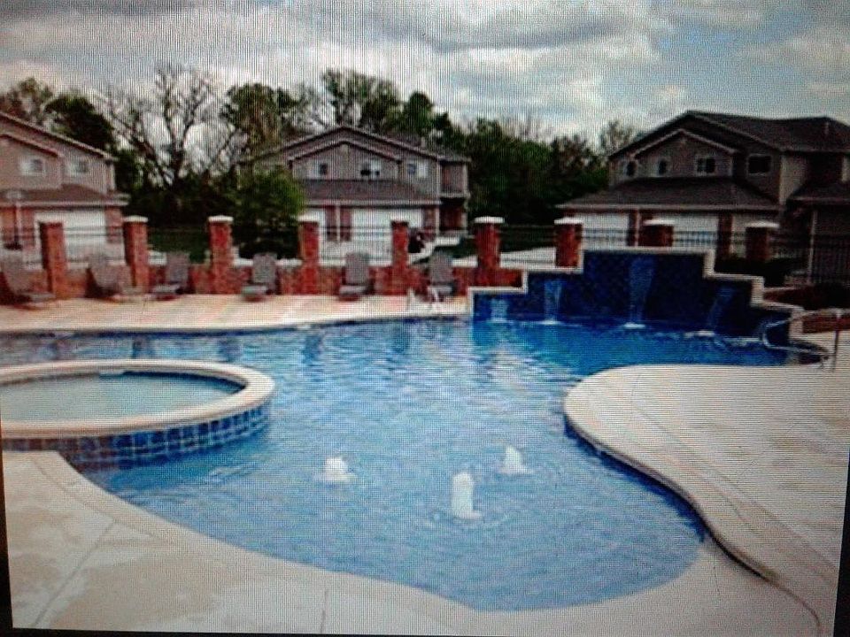 Zero entry swimming pool with waterfalls