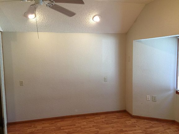 Nice size bedroom with high ceilings and fan.