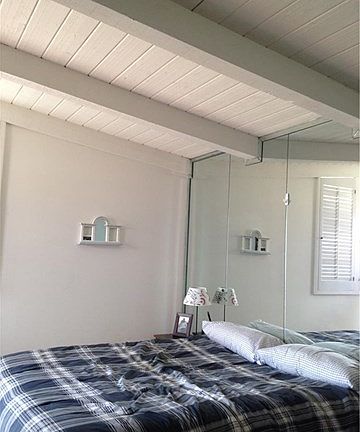 The master bedroom has beamed ceiling.