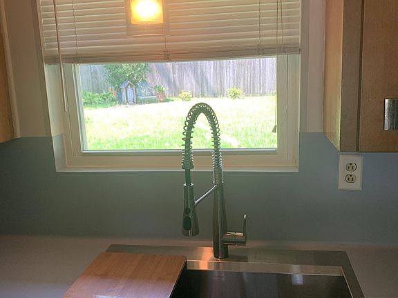 New kitchen sink installed overlooking fenced in back yard