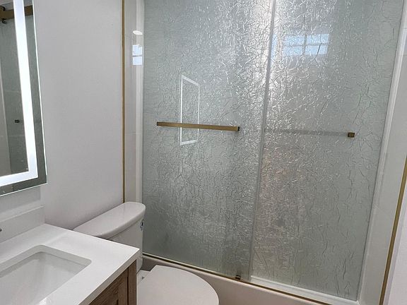 Bathroom with tub, niche, window and beautiful shower doors.