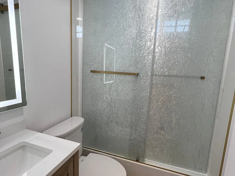 Bathroom with tub, niche, window and beautiful shower doors.