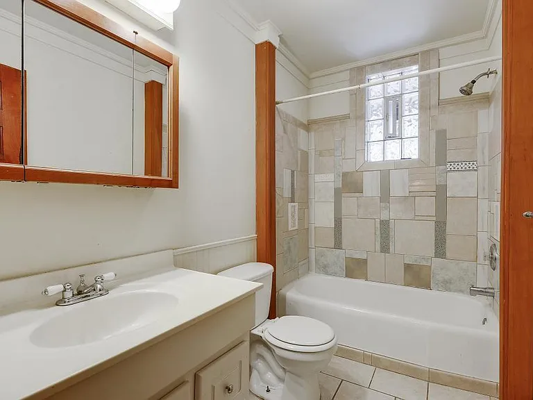 Bathroom is next to the bedroom and off of the kitchen.
