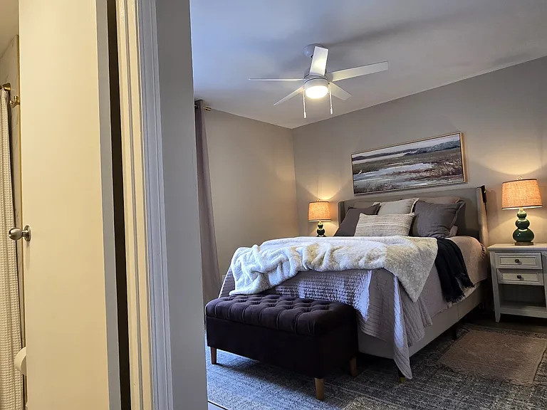 Primary bedroom with a comfortable layout, walk-in closet, and private en suite bathroom. Includes a spa-like linen closet stocked with bath essentials, bedding, and cleaning supplies.