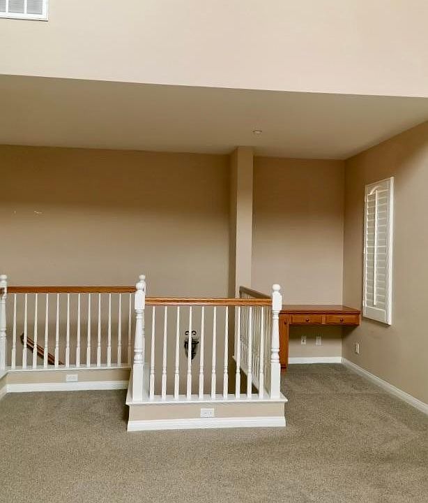 High ceiling family room with fire place and computer nook.