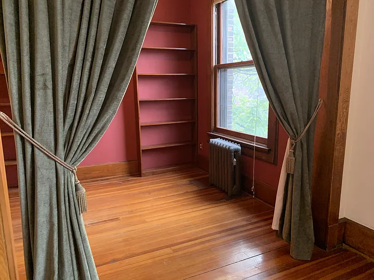 Office has built-in shelving and large window (faces west)